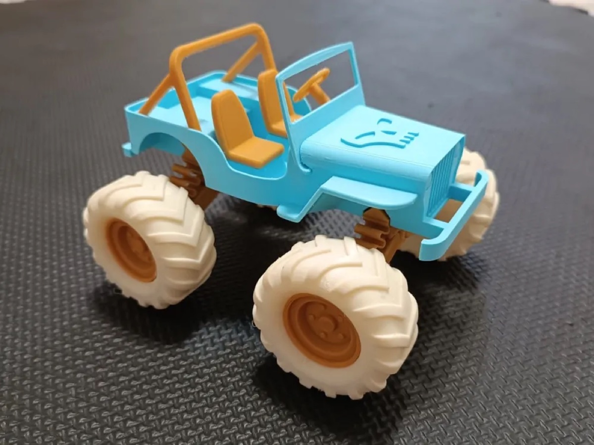 Toy jeep on monster truck wheels